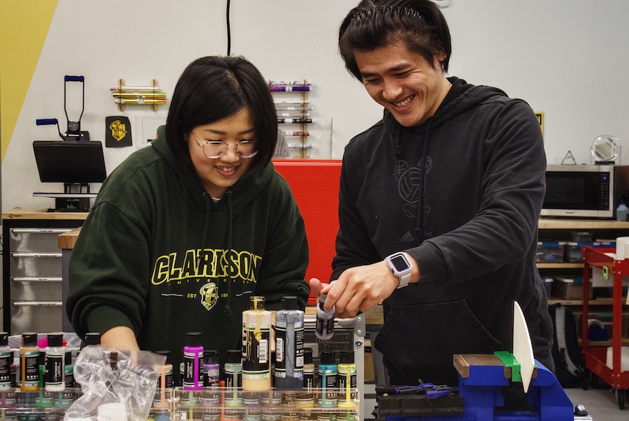 Two students in a lab setting.