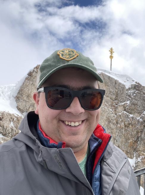 Close up of male student on top of mountain
