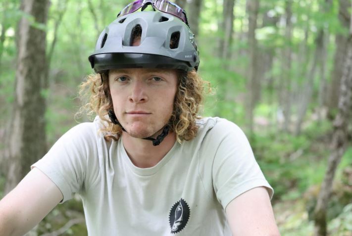 Male student on bike wearing helmet
